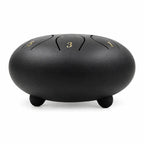 Tongue drum noir de 12 pouces vu de profil, posé sur ses petits pieds